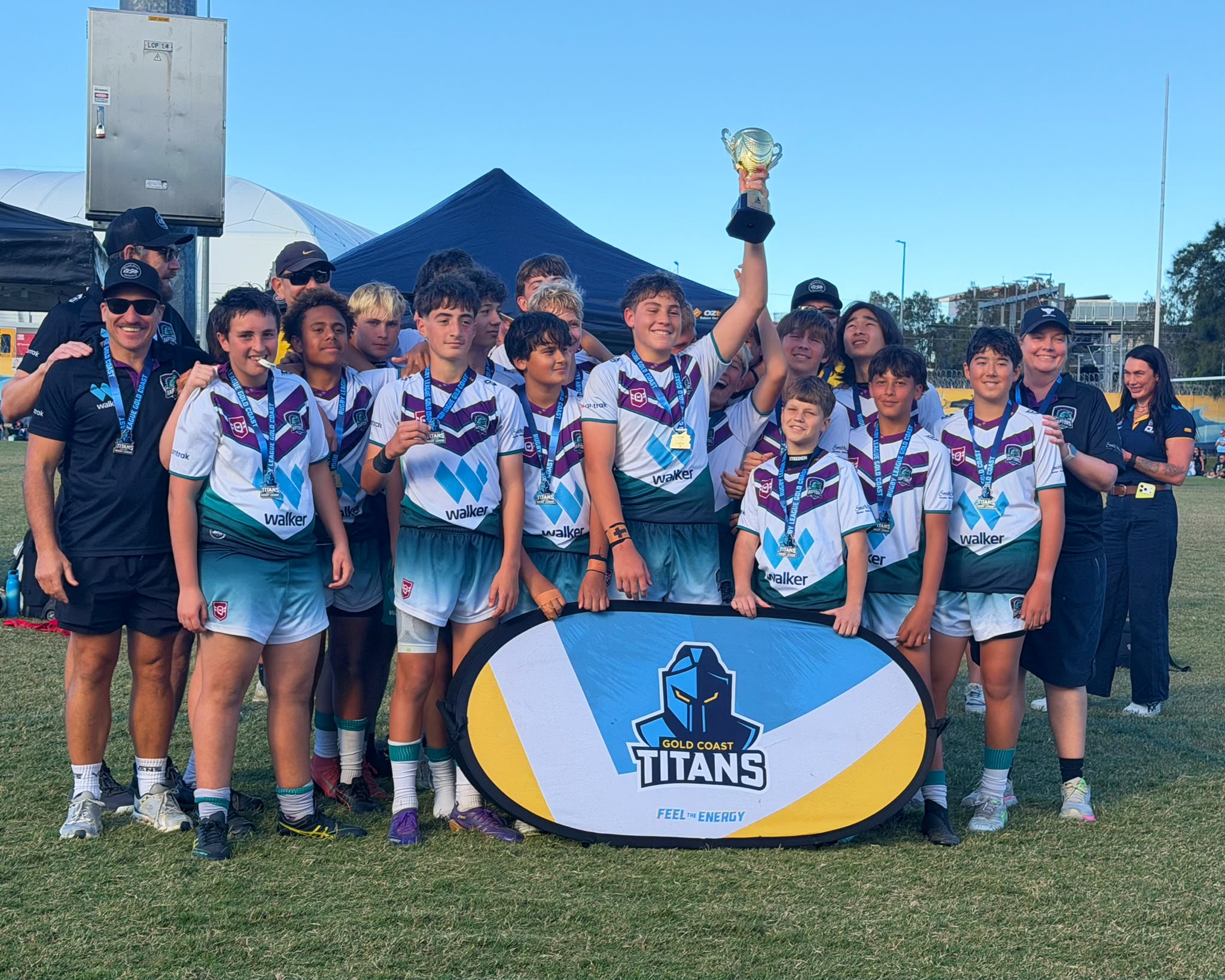 U14s celebrating their grand final win with the trophy